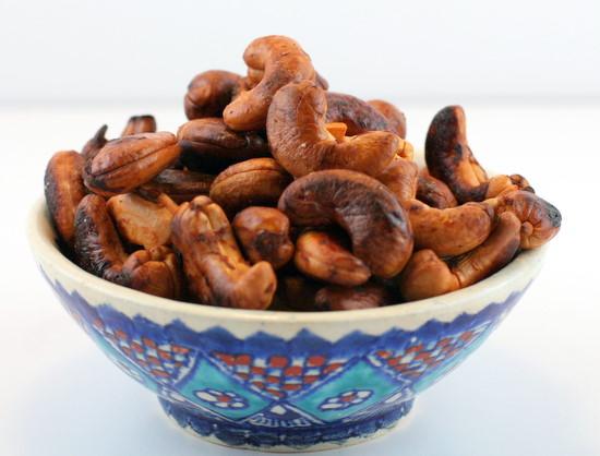 a person preparing lemon garlic roasted cashews in a kitchen