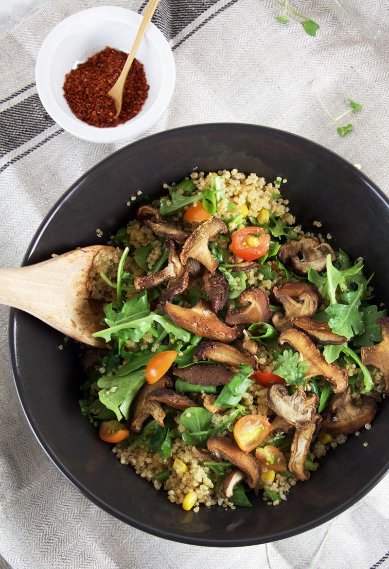 A vibrant quinoa salad with shiitake mushrooms, vibrant vegetables, and a ginger dressing
