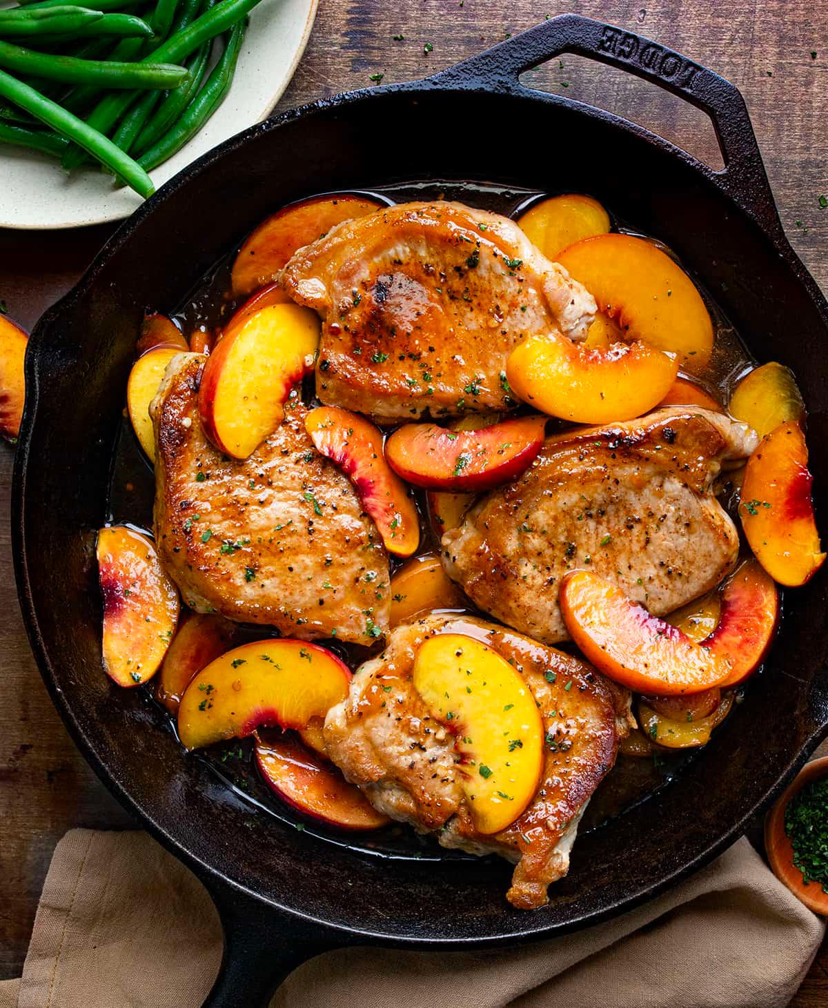 ingredients for pressure cooker peach glazed pork chops laid out on a wooden table