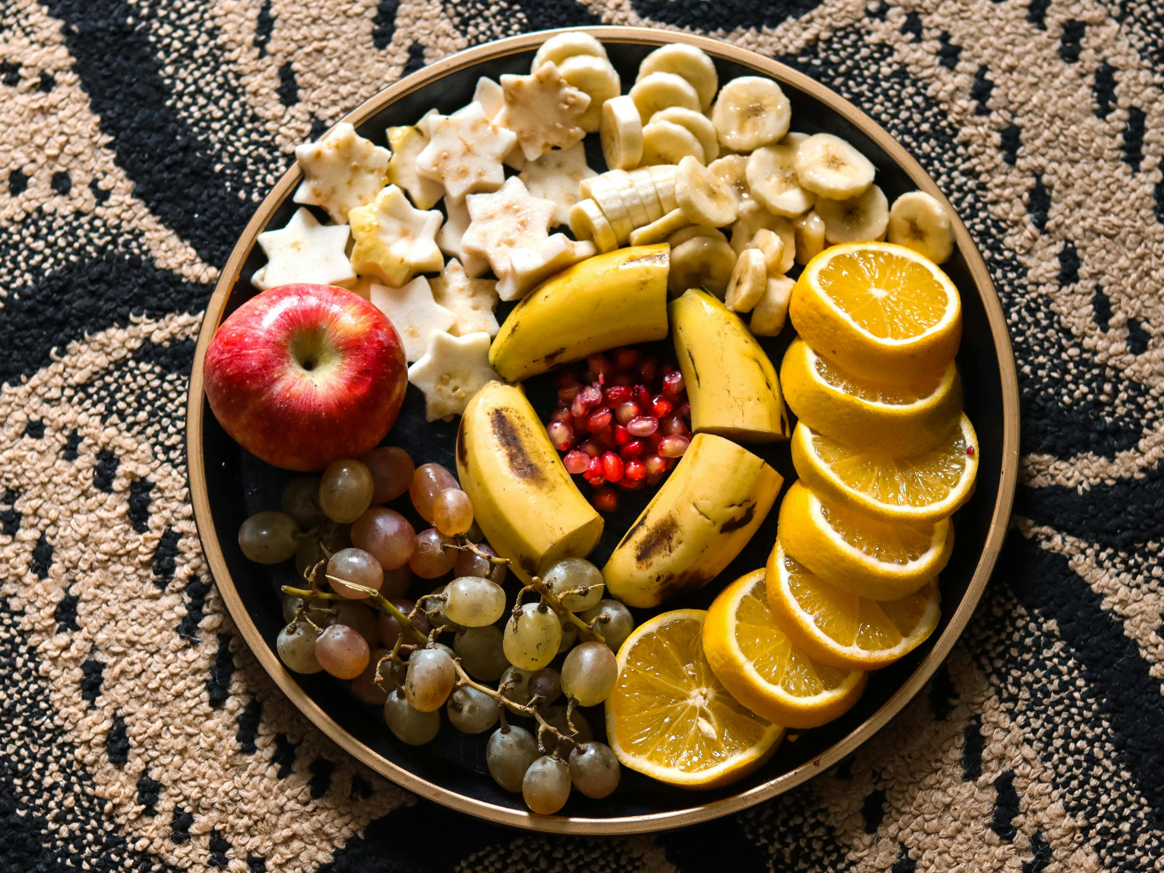 A close-up shot of various types of fruits arranged attractively on a plate