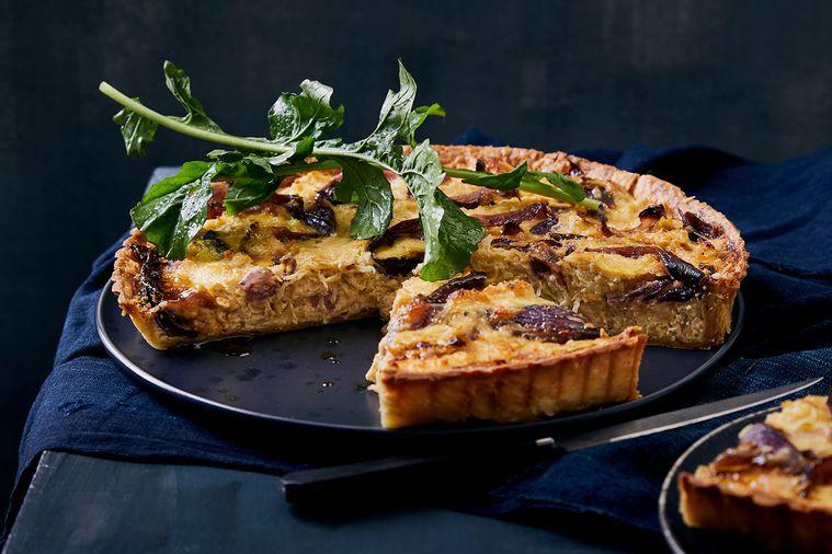 ingredients for sauerkraut and gruyere quiche laid out on a wooden surface