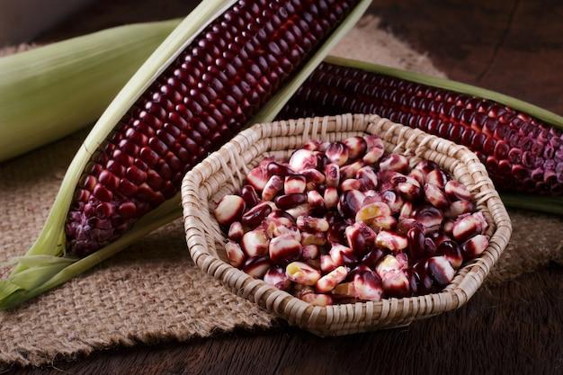 purple corn cobs on a rustic table