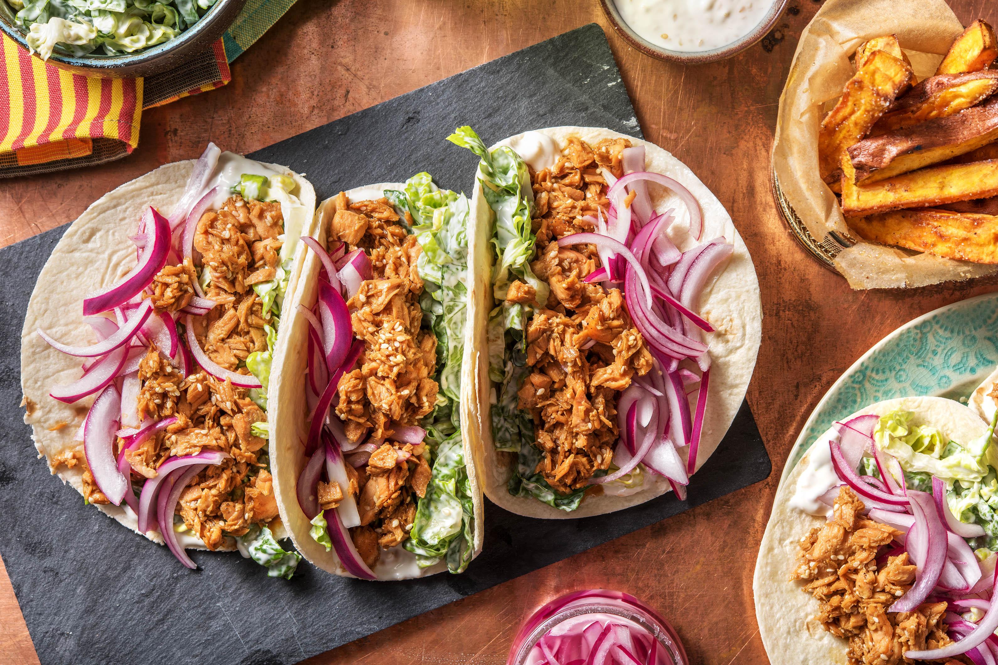 A person happily enjoying Kimchi-Teriyaki Salmon Tacos