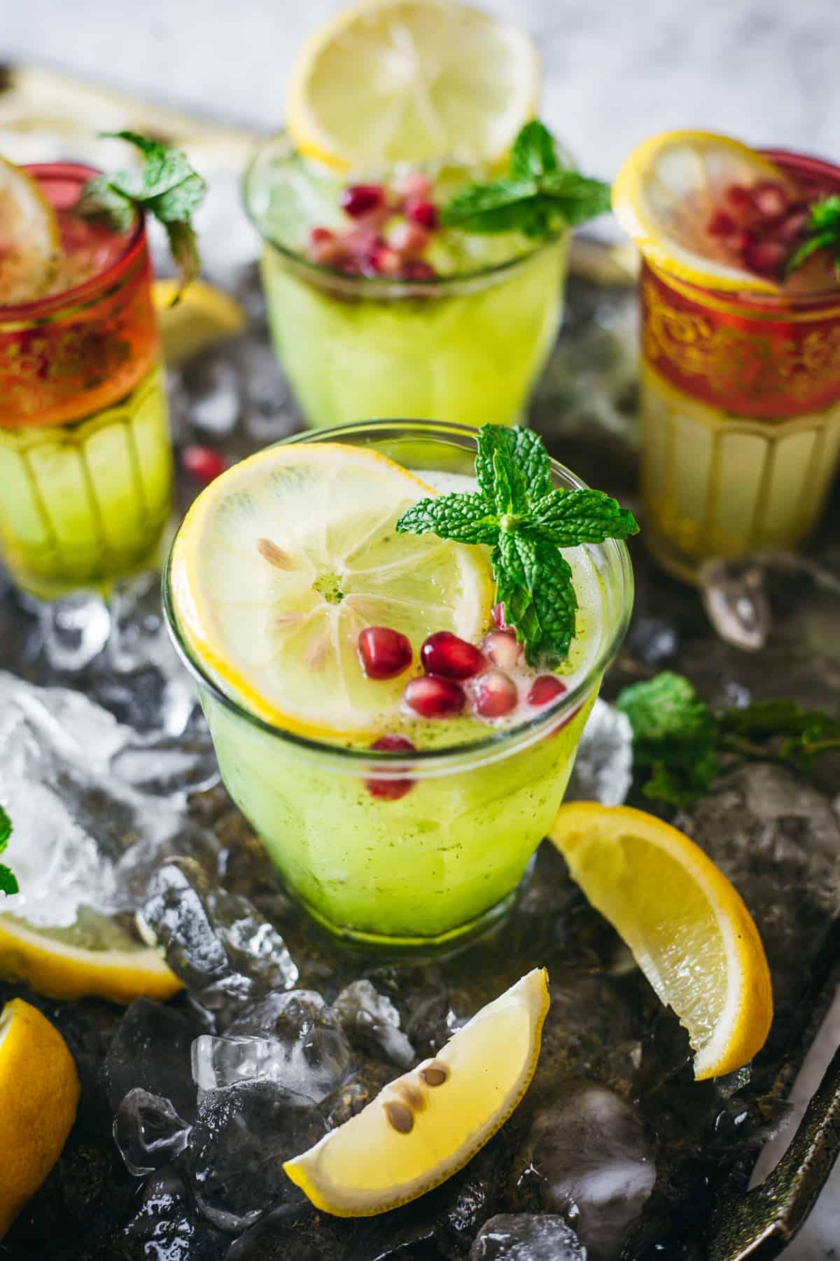 Close-up of a pitcher of green apple mint lemonade with ice and mint sprigs
