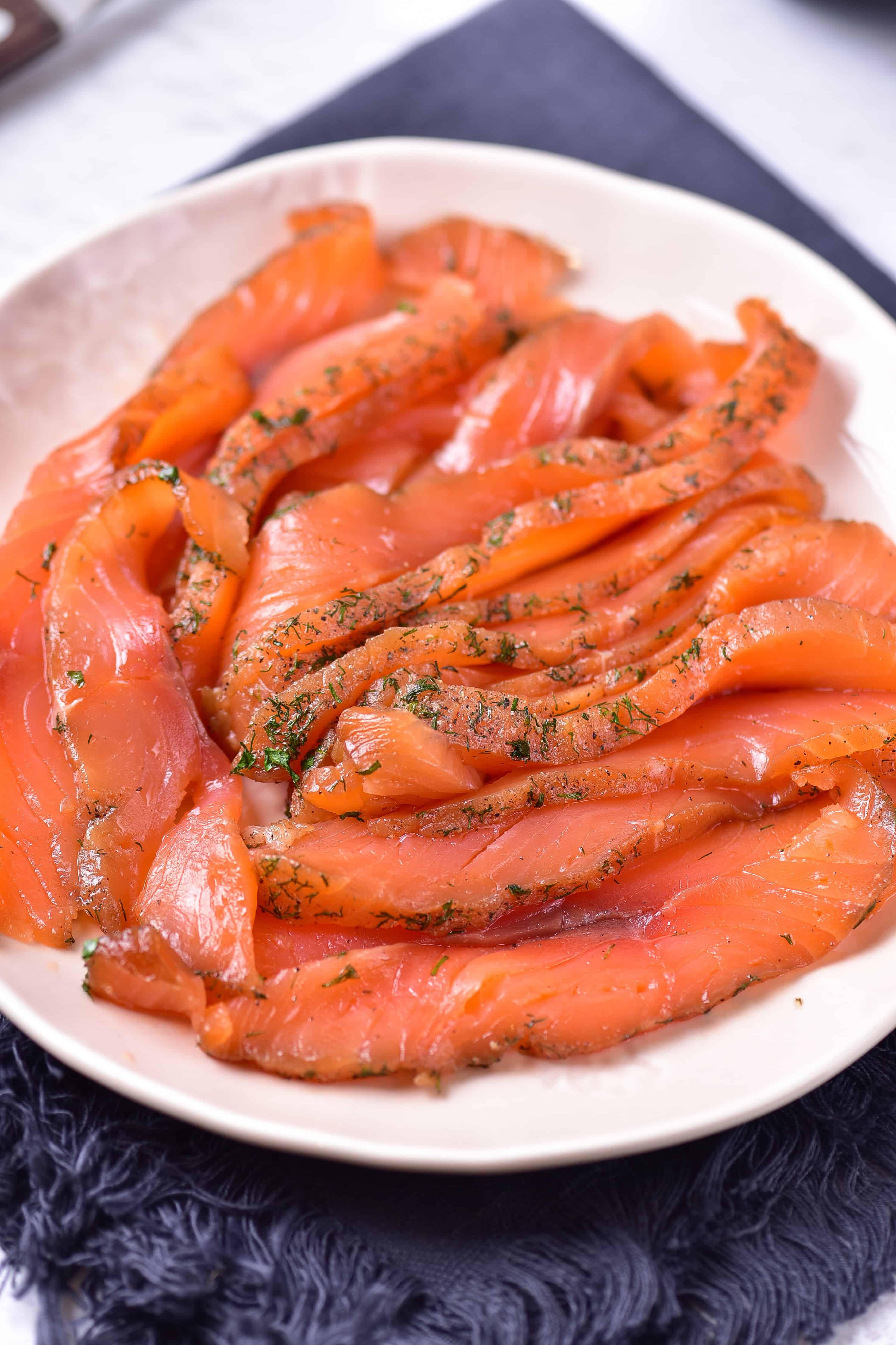 A platter of smoked paprika gravlax with orange segments, garnished with fresh dill, ready to be served