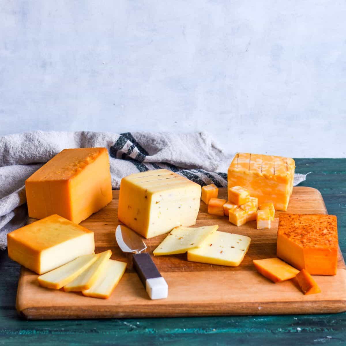 Close-up shot of golden-brown smoked cheese cubes on a wooden board
