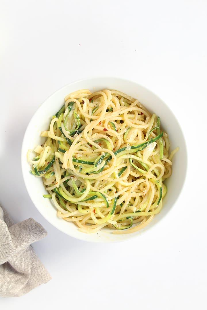 close up shot of zoodles with garlic parmesan sauce and roasted vegetables