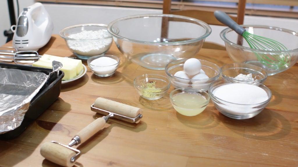 ingredients for white currant lemon bars arranged on a wooden table
