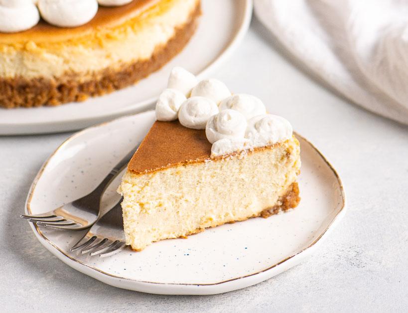overhead shot of a beautifully presented vanilla bean cheesecake with a golden-brown crust