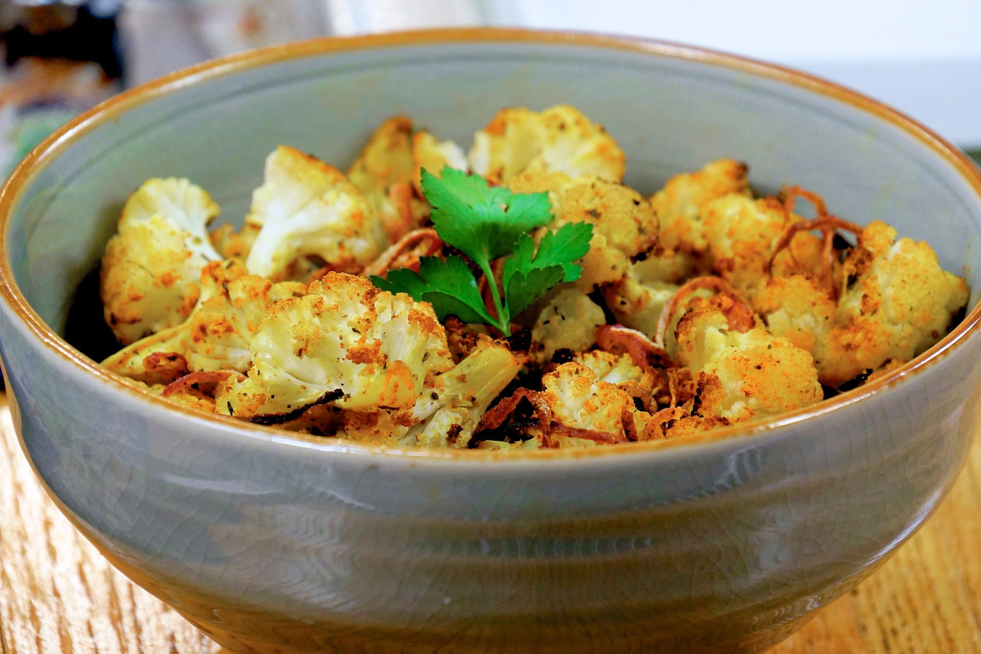 A vibrant close-up shot of paprika-roasted cauliflower rice, showcasing its golden-brown color and texture.