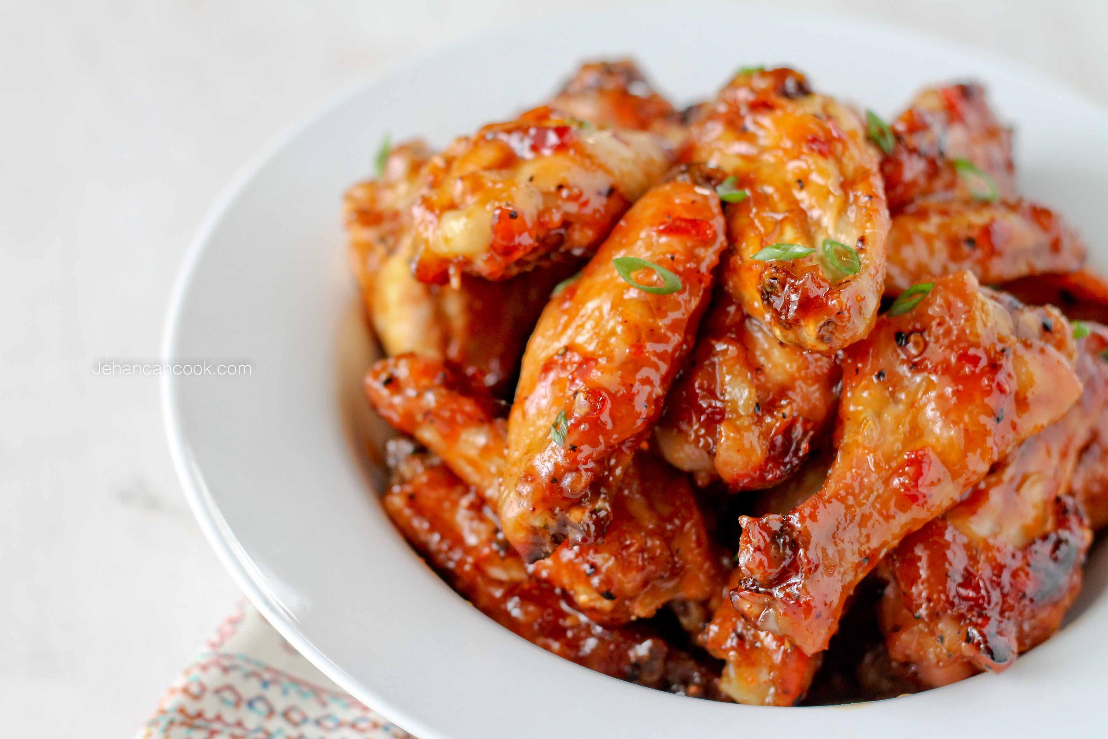A vibrant image of Spicy Pineapple Wings, showcasing the pineapple chunks and the glossy sauce