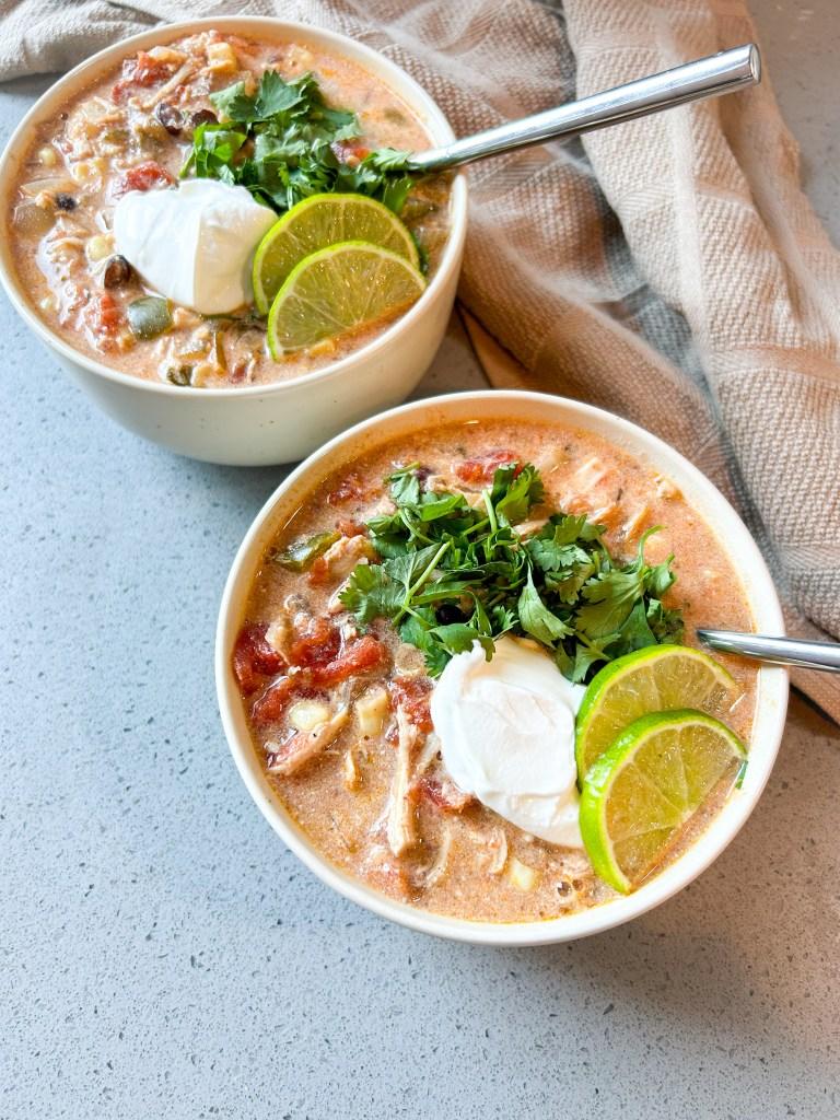 A person enjoying a bowl of zesty chicken tortilla soup in a cozy setting