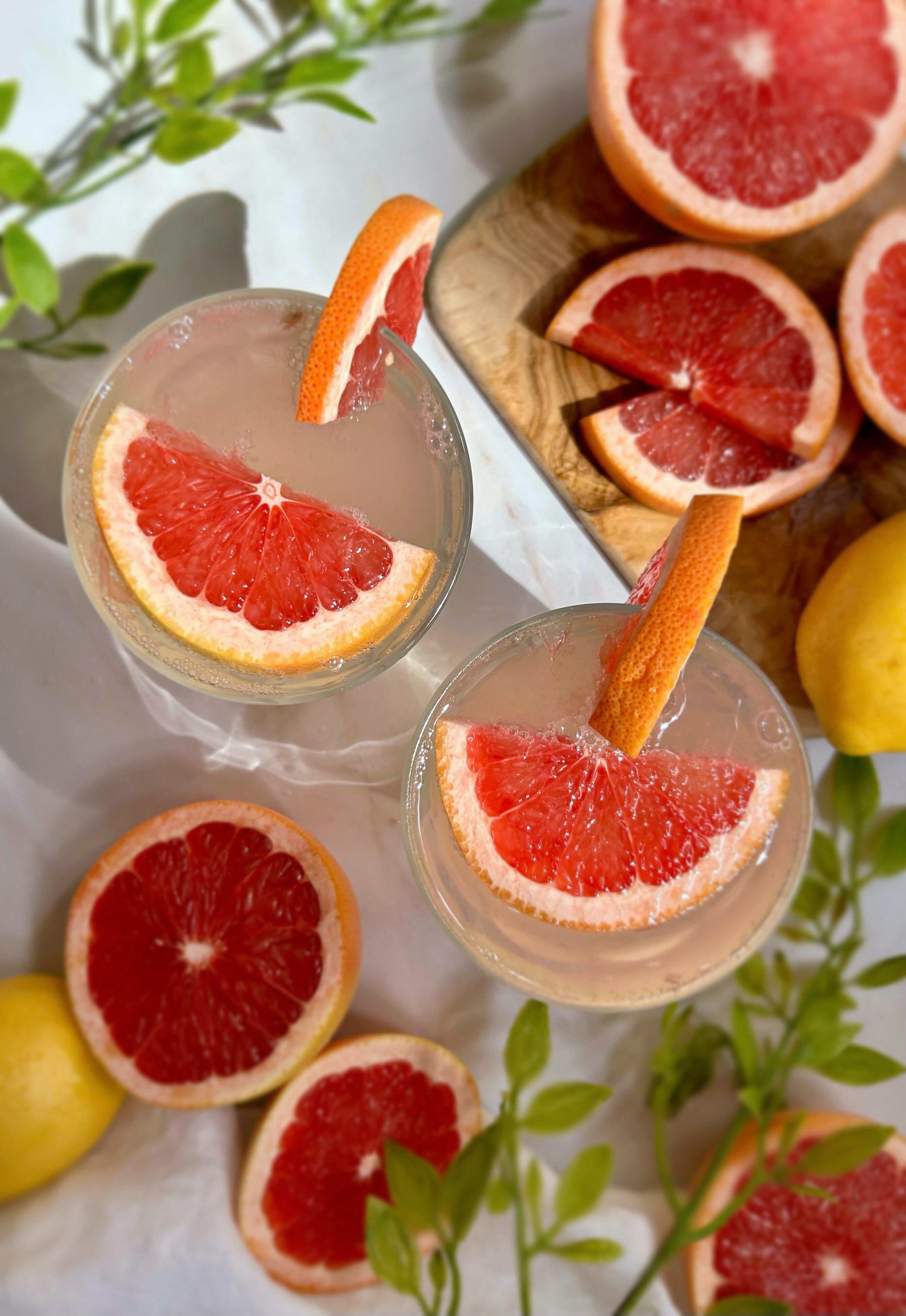 Close-up shot of a glass of pink grapefruit lemonade, garnished with a pink grapefruit slice