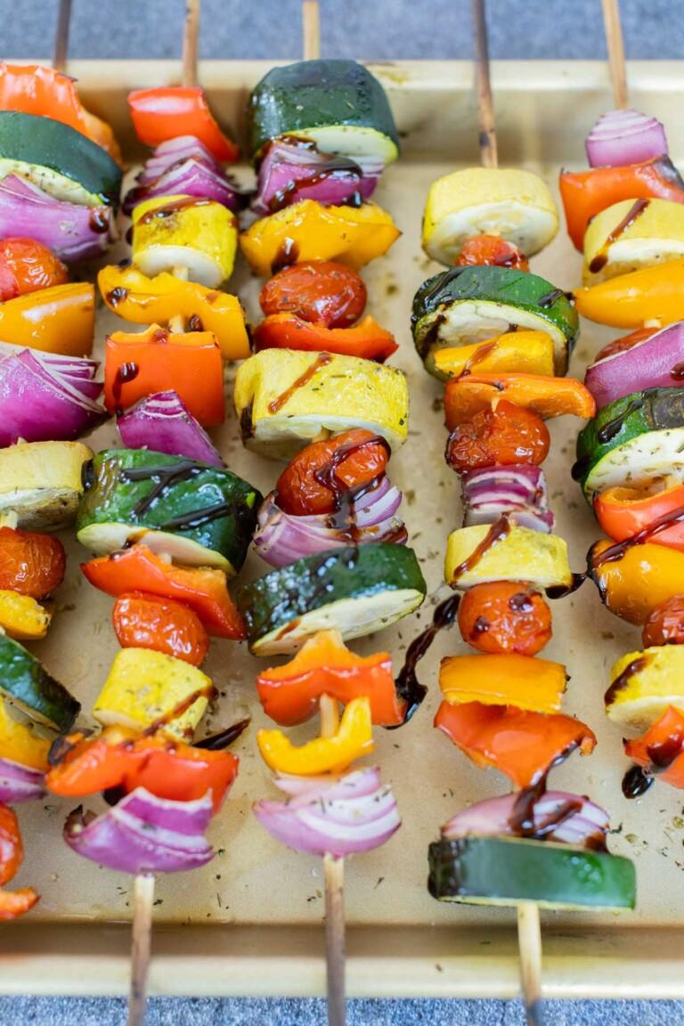 close-up of colorful rainbow veggie skewers with bell peppers, cherry tomatoes, zucchini, and red onions