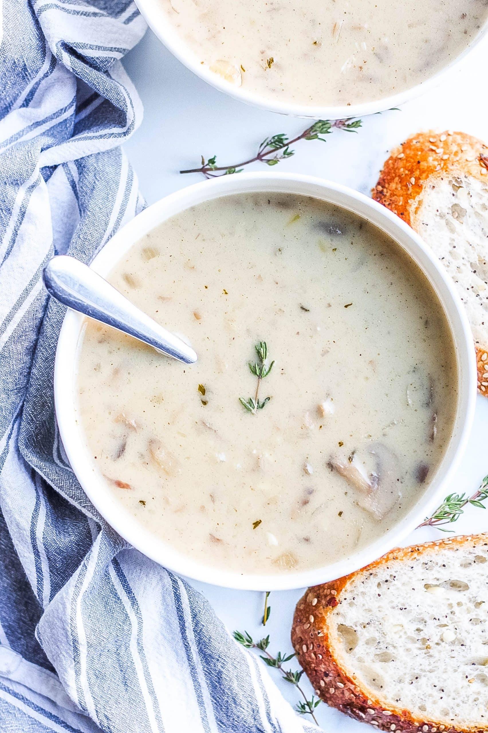 Close up of a steaming bowl of creamy mushroom soup