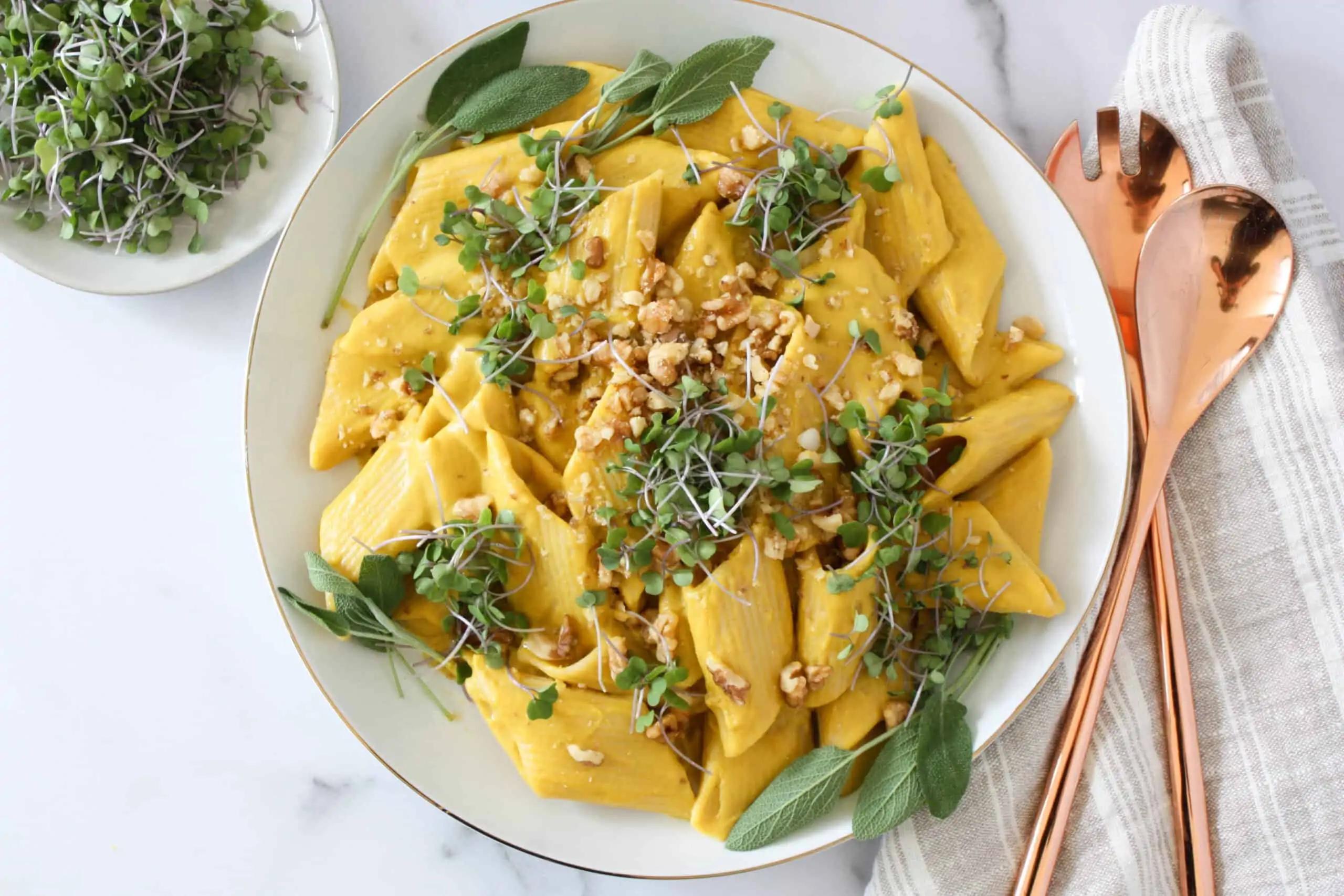 A rustic, homey setting with a bowl of butternut squash pasta garnished with fresh basil