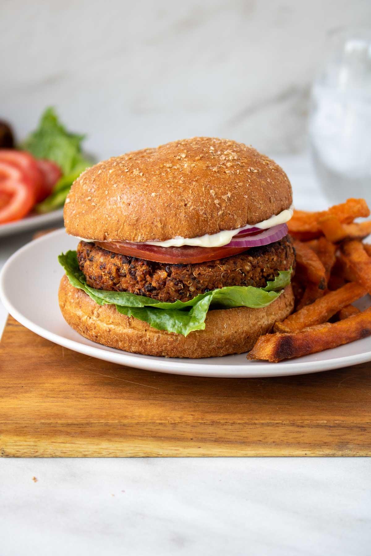 Close-up of uncooked quinoa veggie burger patties on parchment paper.