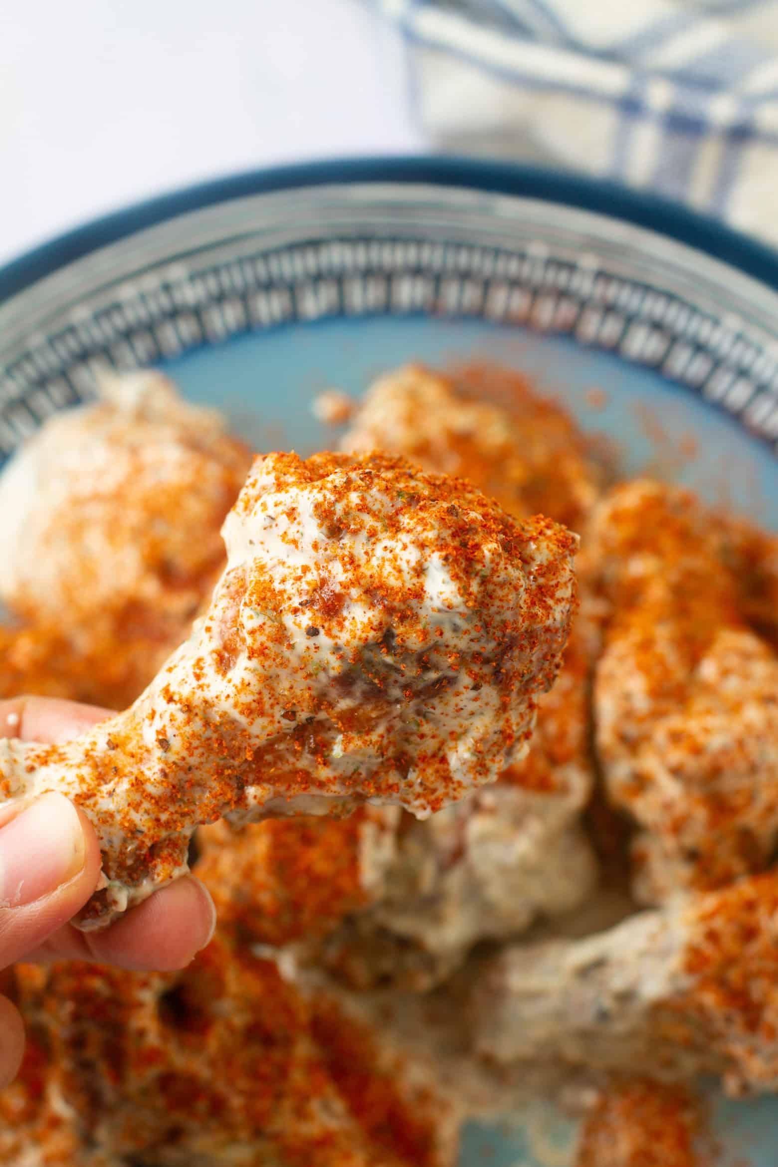 A platter of golden-brown Cajun Ranch Wings, with a bowl of ranch dressing in the foreground.
