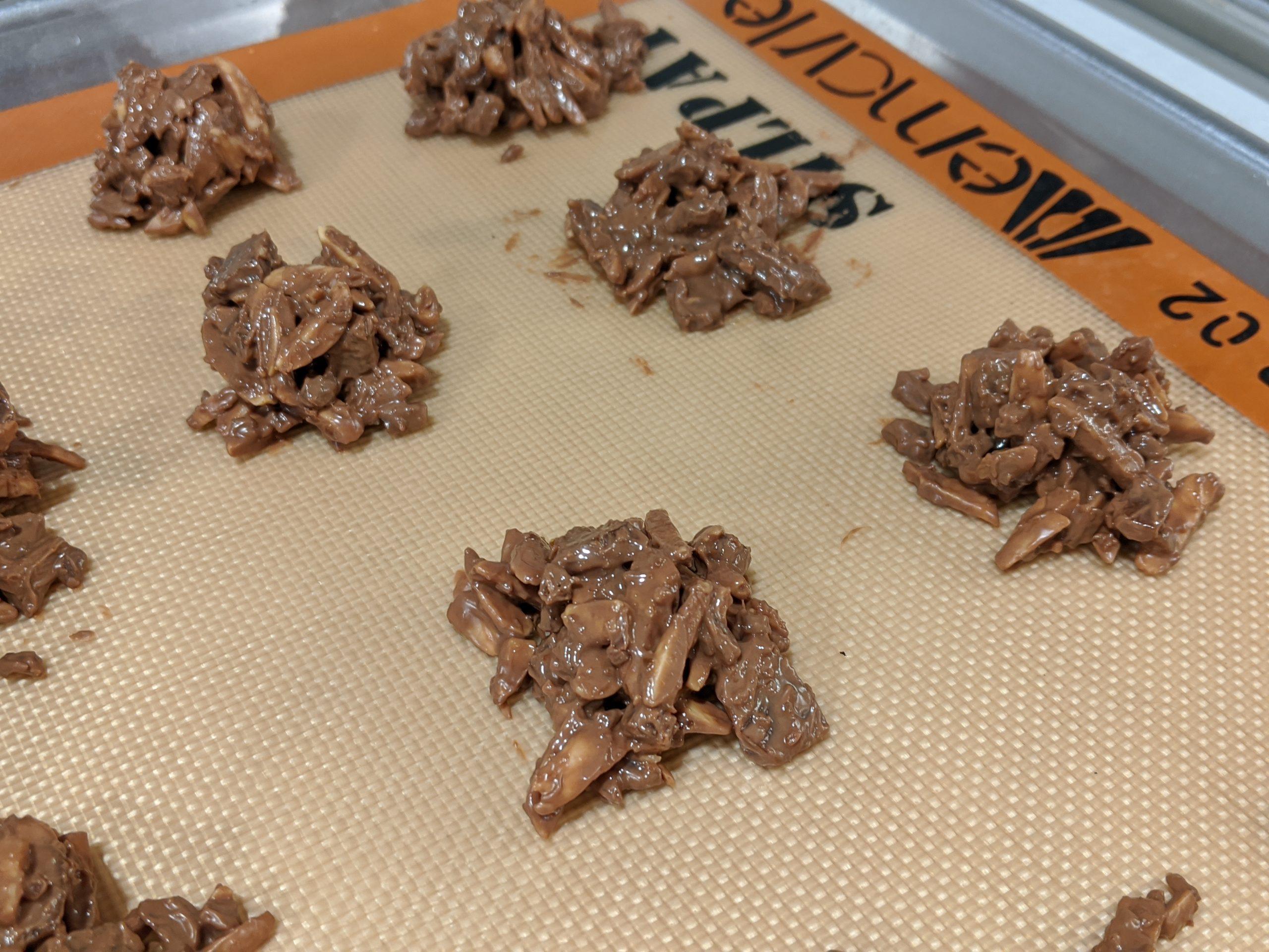 close-up shot of golden almond toffee pieces broken on a cutting board