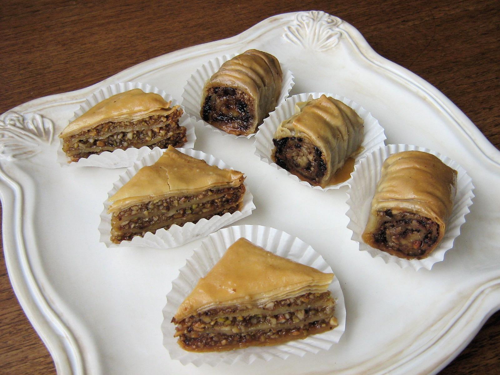 A close-up shot of a person meticulously layering phyllo dough for baklava