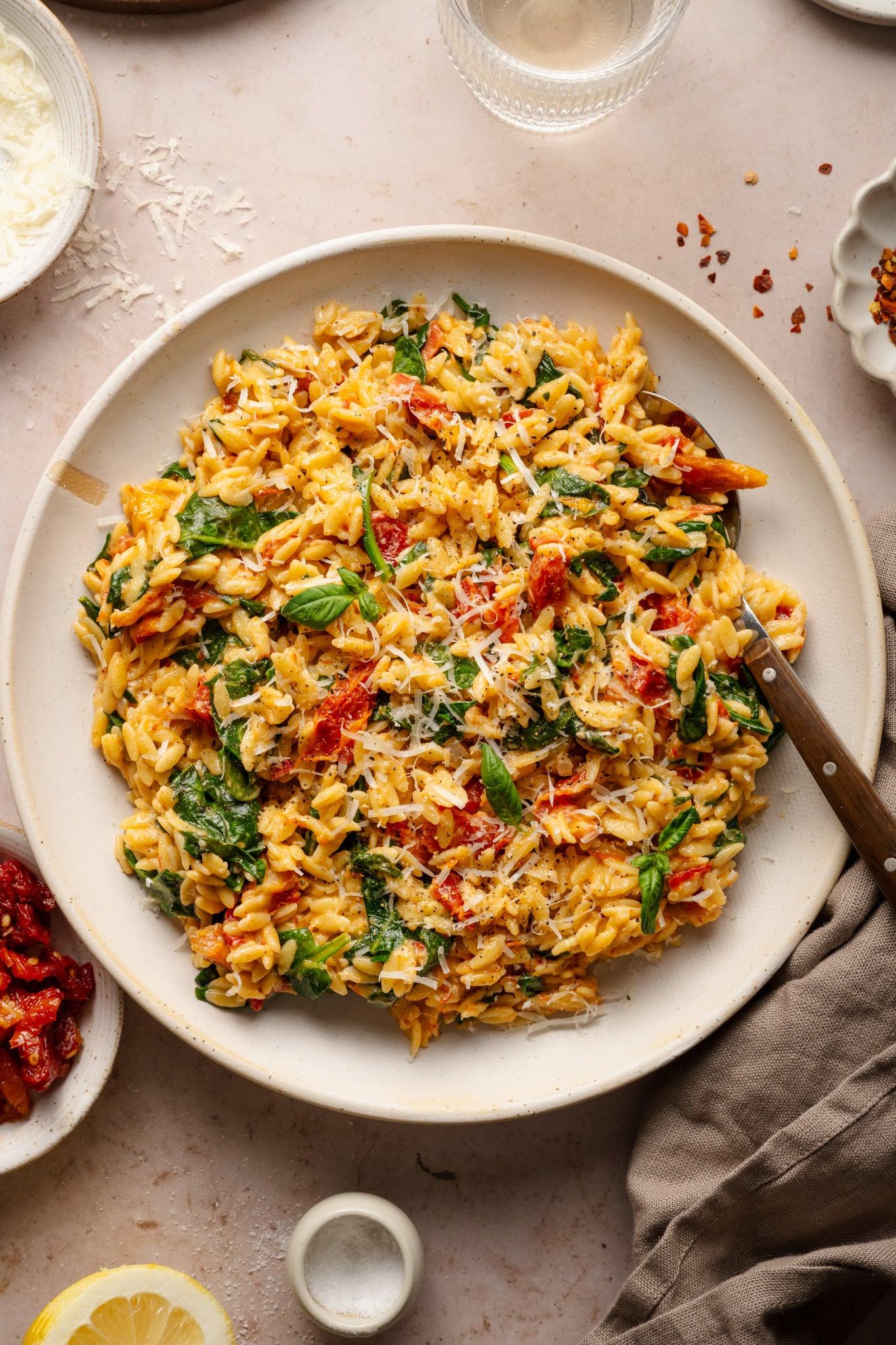 A wide shot showing multiple servings of Creamy Tomato and Spinach Fried Rice Bowls arranged on a table.