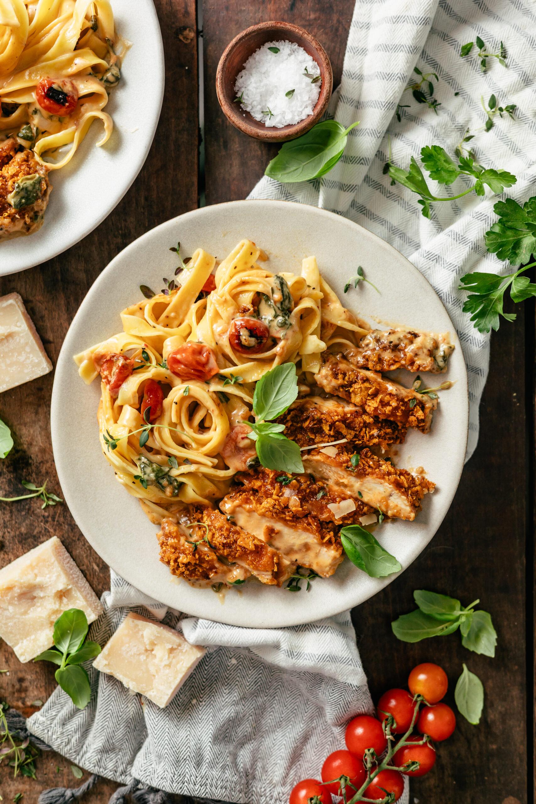 Vibrant creamy Cajun chicken pasta served in a shallow bowl, garnished with fresh parsley.