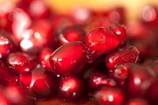 close up of pomegranate arils and fresh ginger