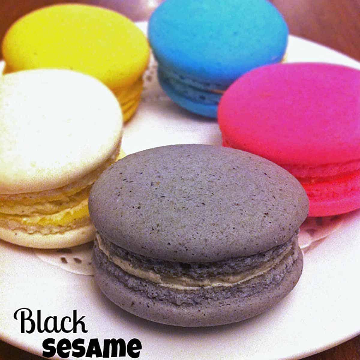 A plate of kimchi macarons with black sesame filling, beautifully arranged