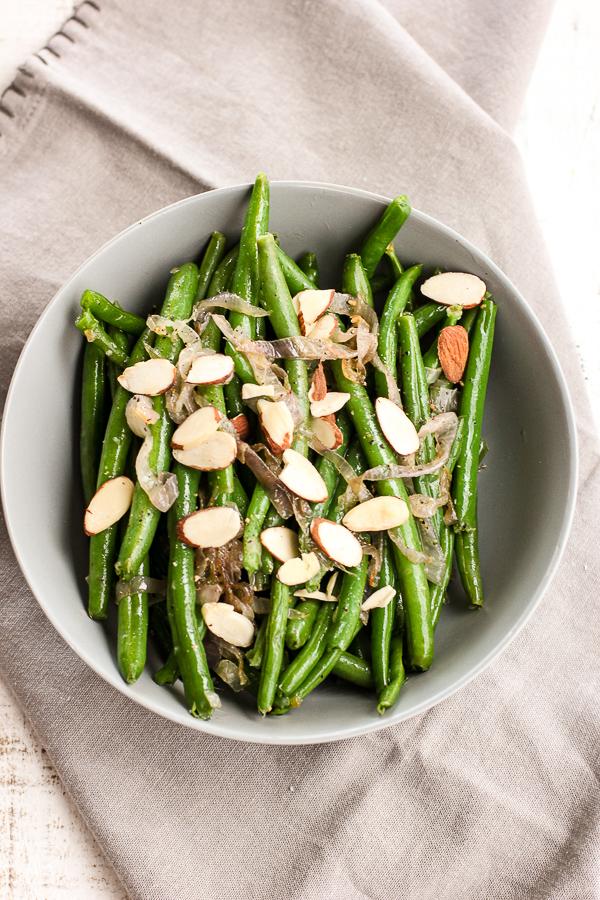 plate of butter braised green beans with shallots, elegant side dish