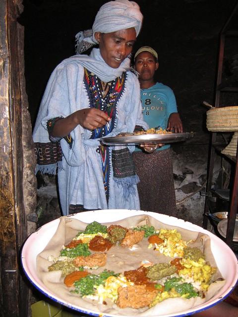 Ethiopian woman preparing injera with spiced butter