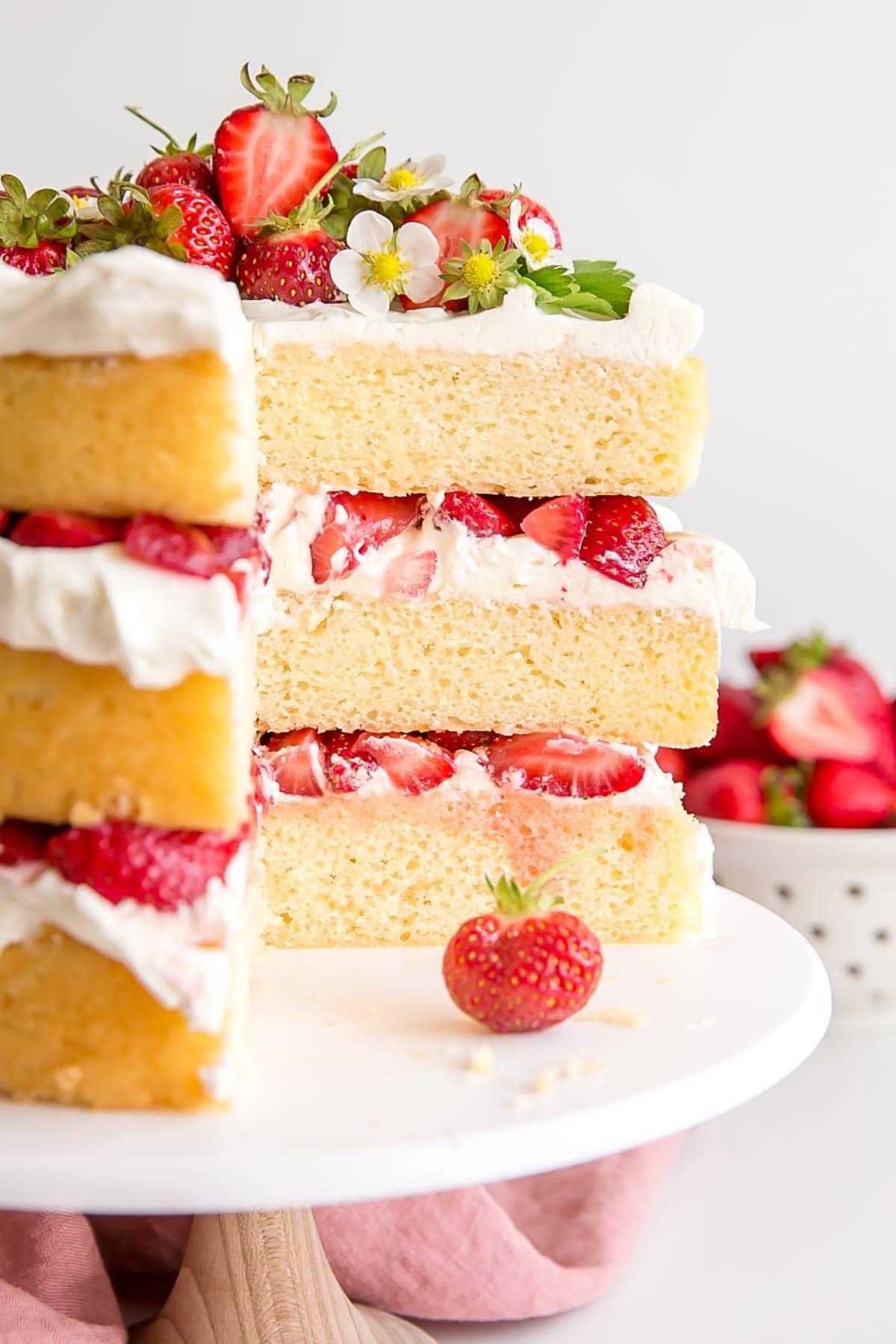 Close-up shot of a single strawberry shortcake, showing the layers of biscuit, mascarpone cream, and strawberries