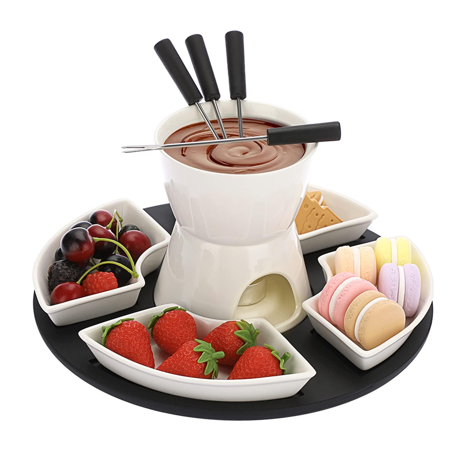 A rustic wooden table set with a charming chocolate fondue pot surrounded by an assortment of dippers like strawberries, marshmallows, and cookies.