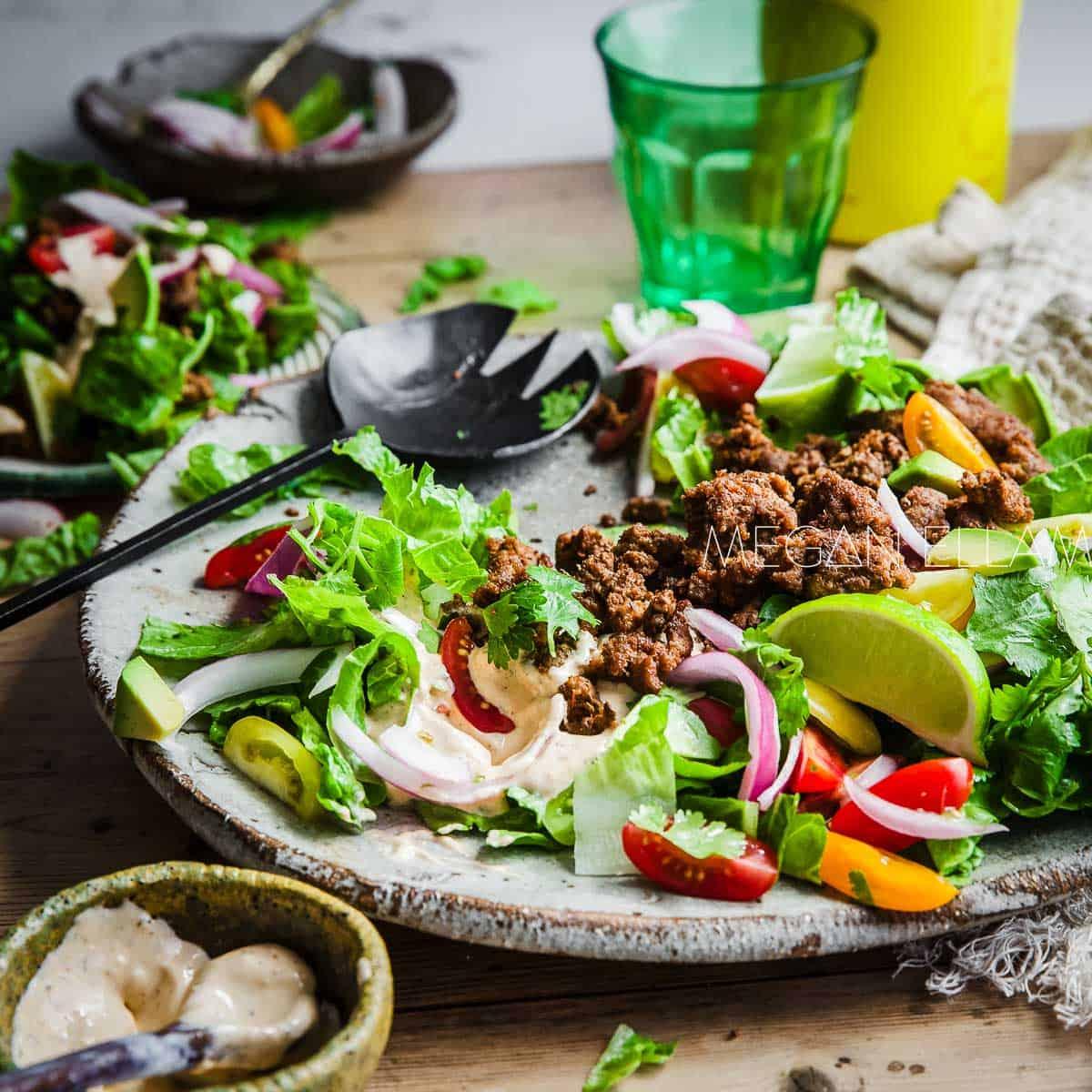 A person enjoying a spoonful of Tex-Mex Keto Avocado & Ground Beef Salad, with a happy and satisfied expression.