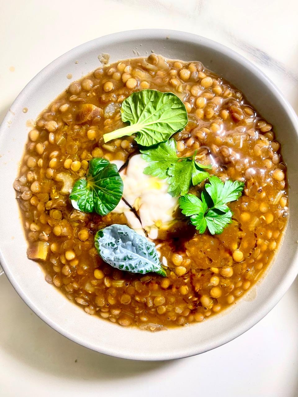 bowl of Moroccan lentil soup garnished with dates and almonds