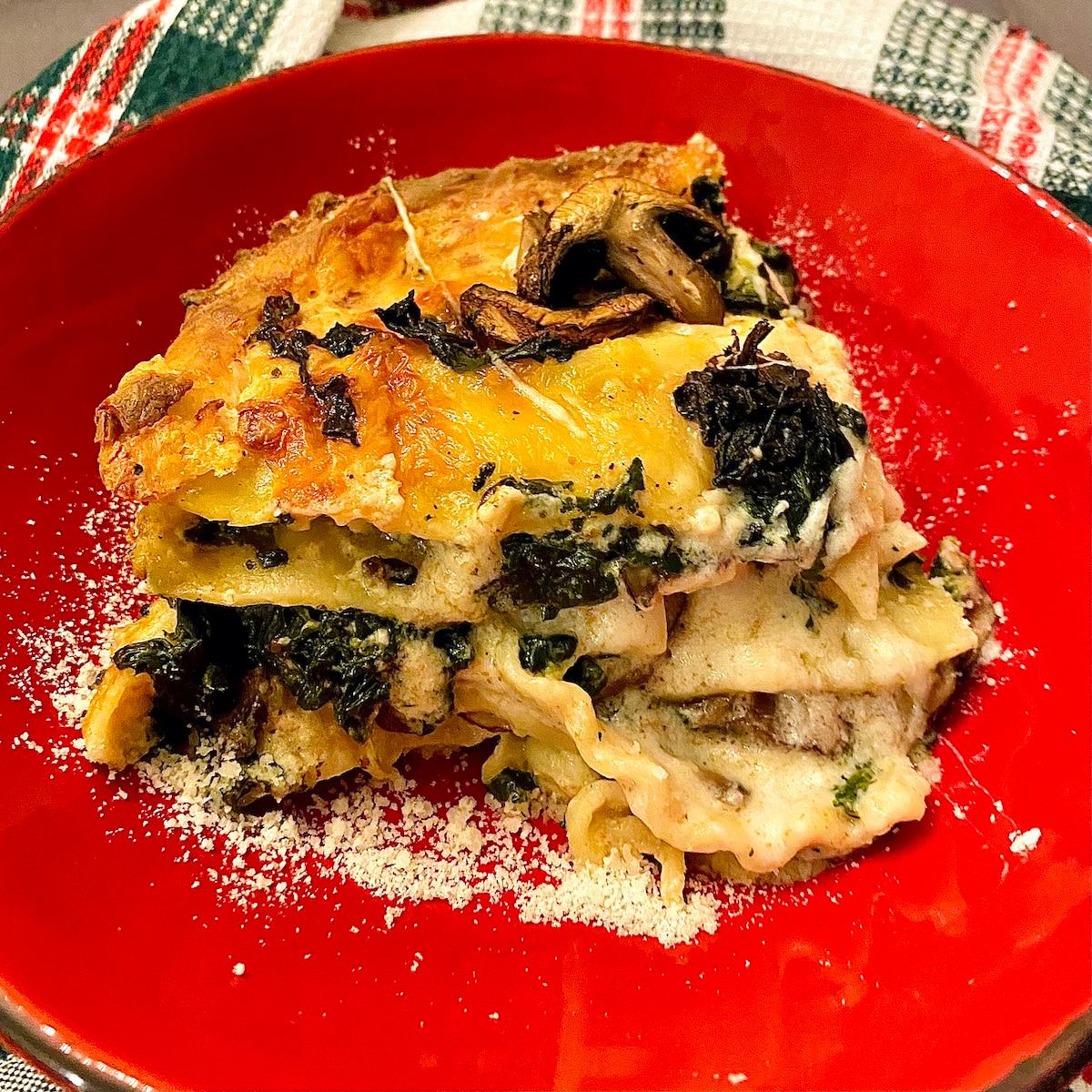 A person carefully layering the roasted vegetables and béchamel sauce in a baking dish