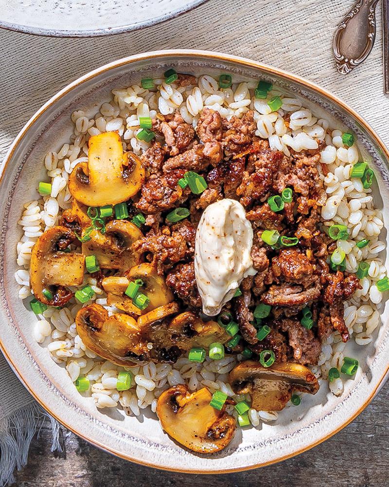 Close-up shot of a rustic bowl of Mushroom and Swiss Rice Bowl, showing the texture and color of ingredients.