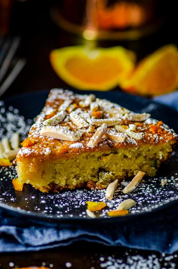 Close-up shot of a moist orange almond cake with a honey glaze, showing texture and detail