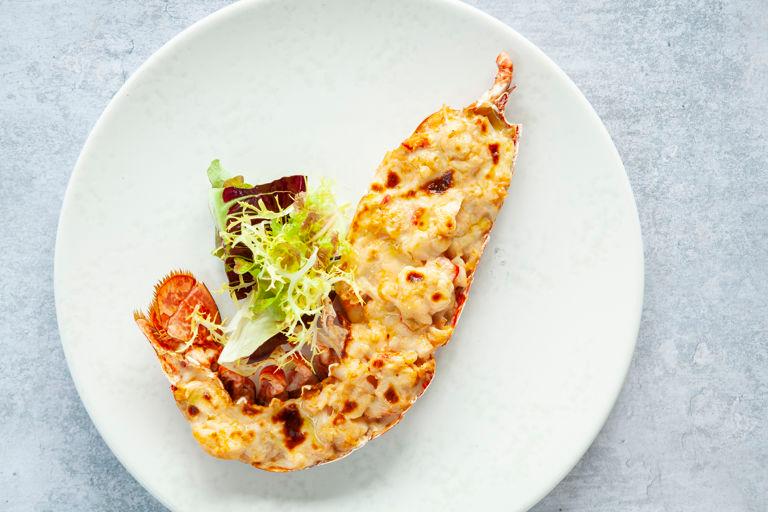 A beautifully arranged platter of Lobster and Gruyere Tart, ready to be served