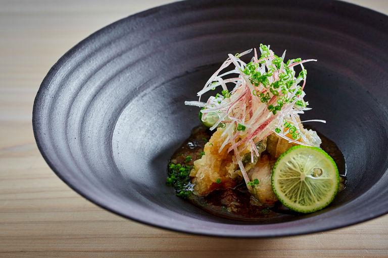 crispy mackerel tempura with daikon radish, close up shot