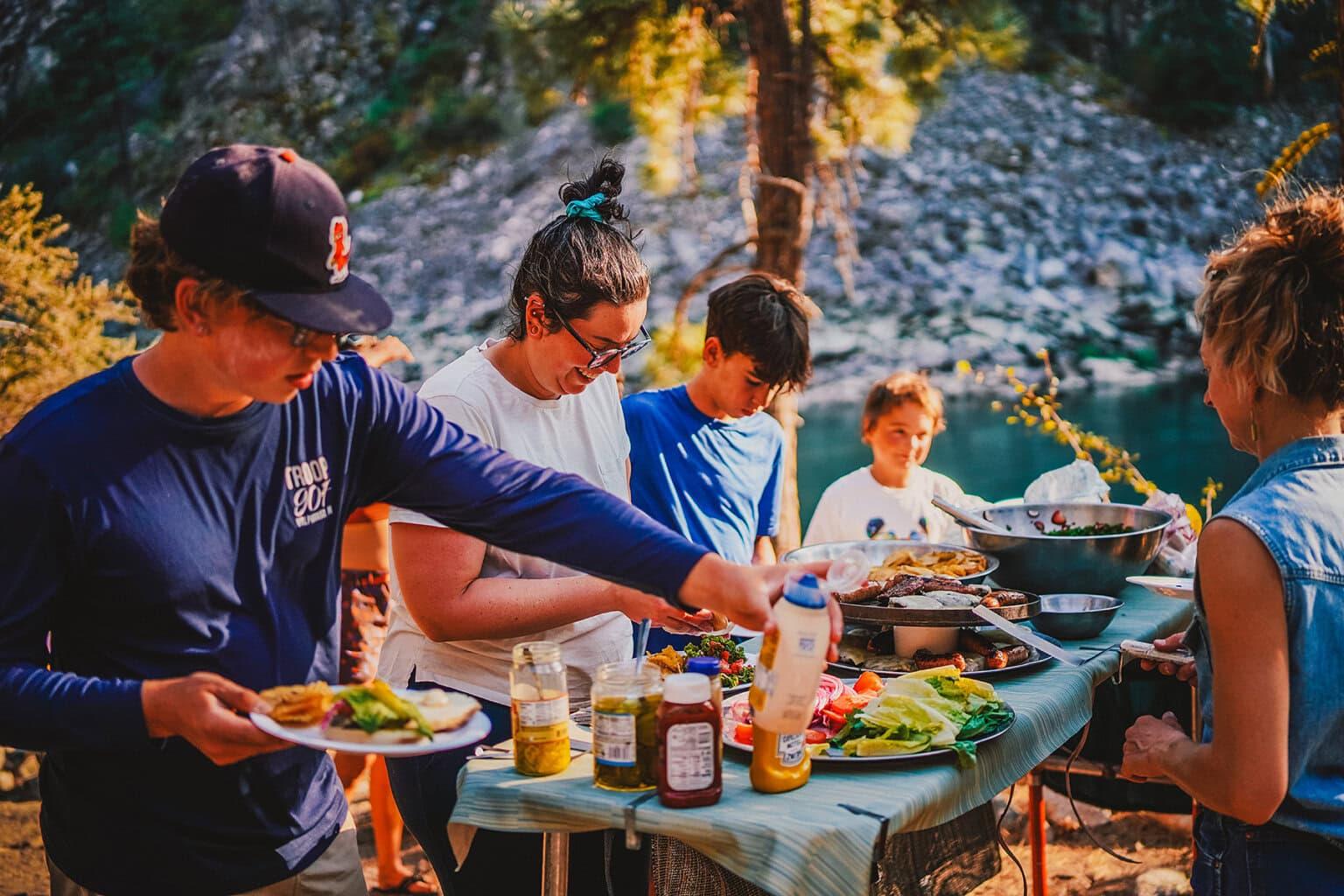 A group of friends enjoying a picnic with the Alaska Salmon Picnic Sandwich
