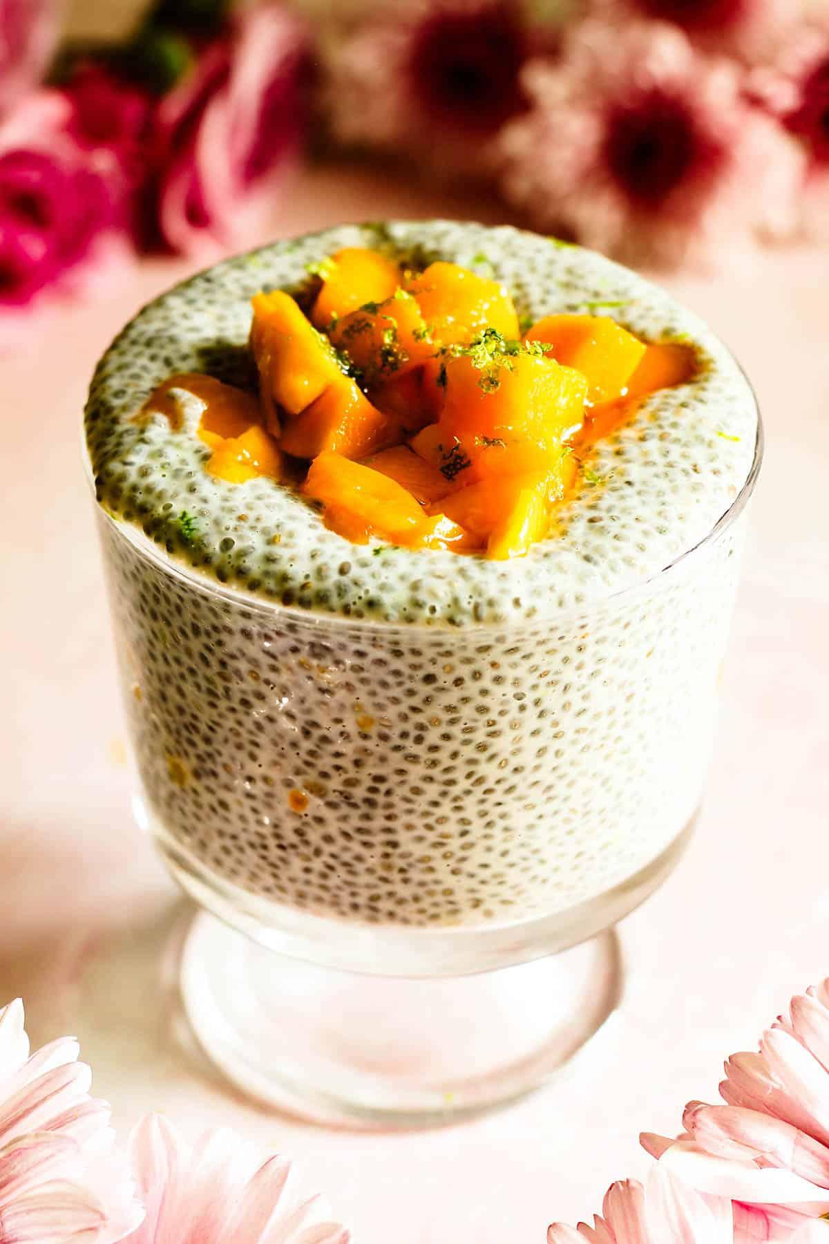 A spoonful of Smoked Paprika Chia Pudding with Corn being lifted from a glass bowl