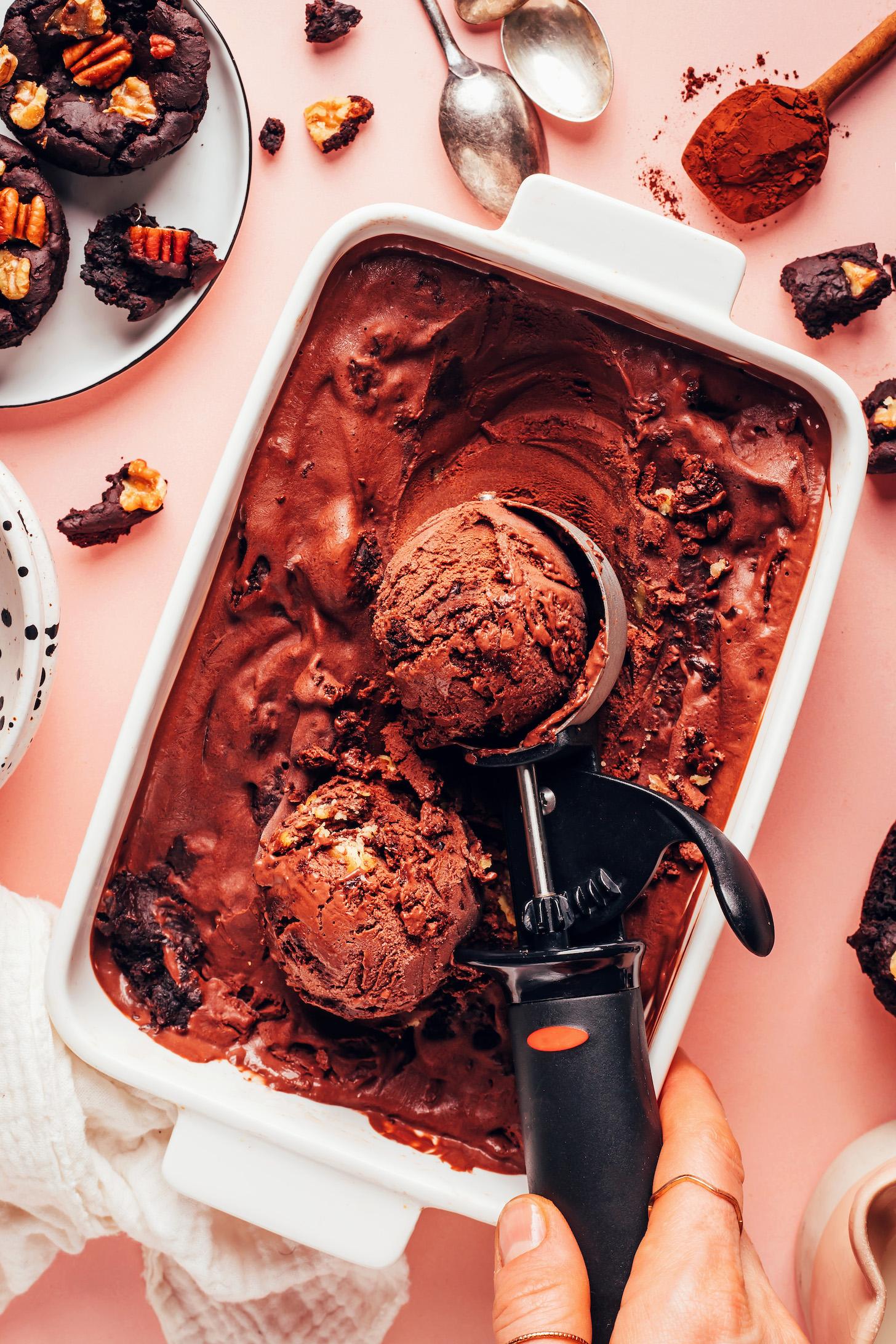 close-up of a scoop of vegan chocolate brownie ice cream dripping off a spoon