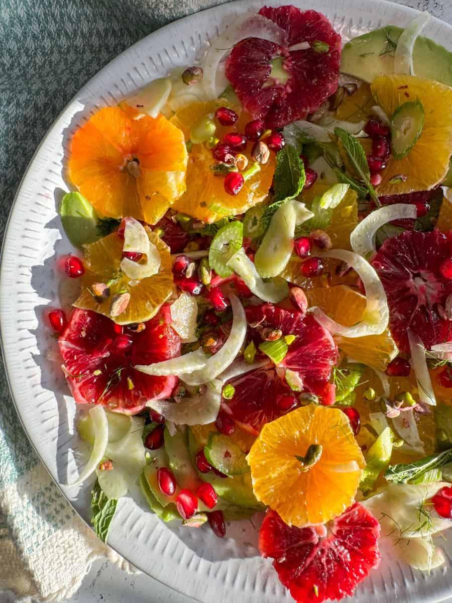 Close-up shot of a vibrant spring citrus salad with a lemon vinaigrette dressing, garnished with fresh herbs