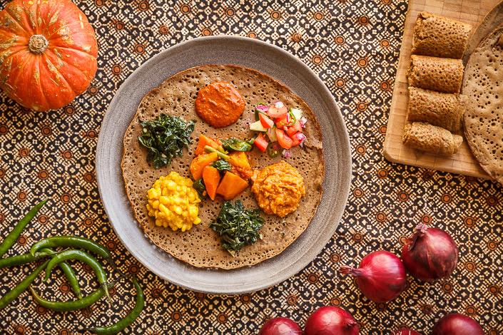 overhead shot of sweet potato injera on a plate