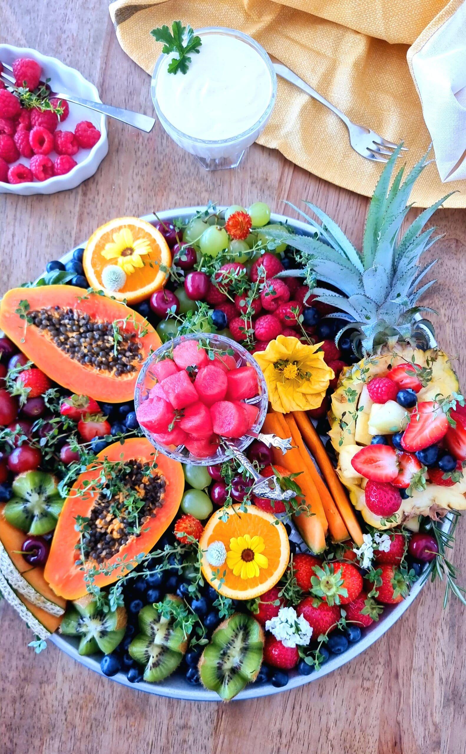 A colorful and beautifully arranged fruit platter with figs as the centerpiece