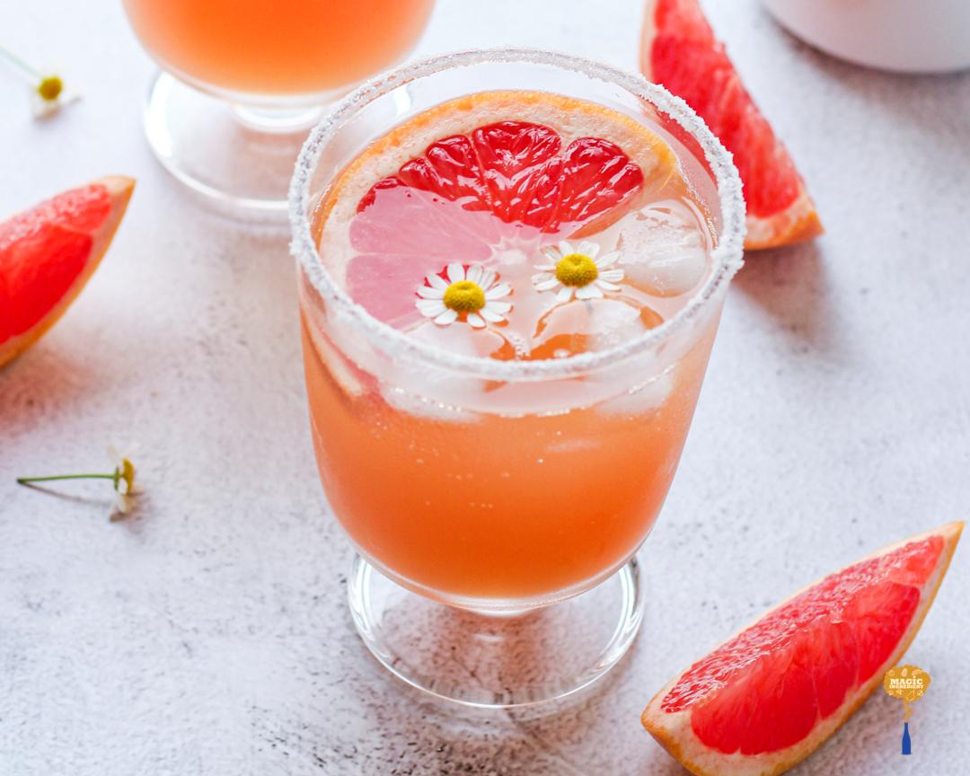 Refreshing glass of pink grapefruit lemonade with honey drizzle