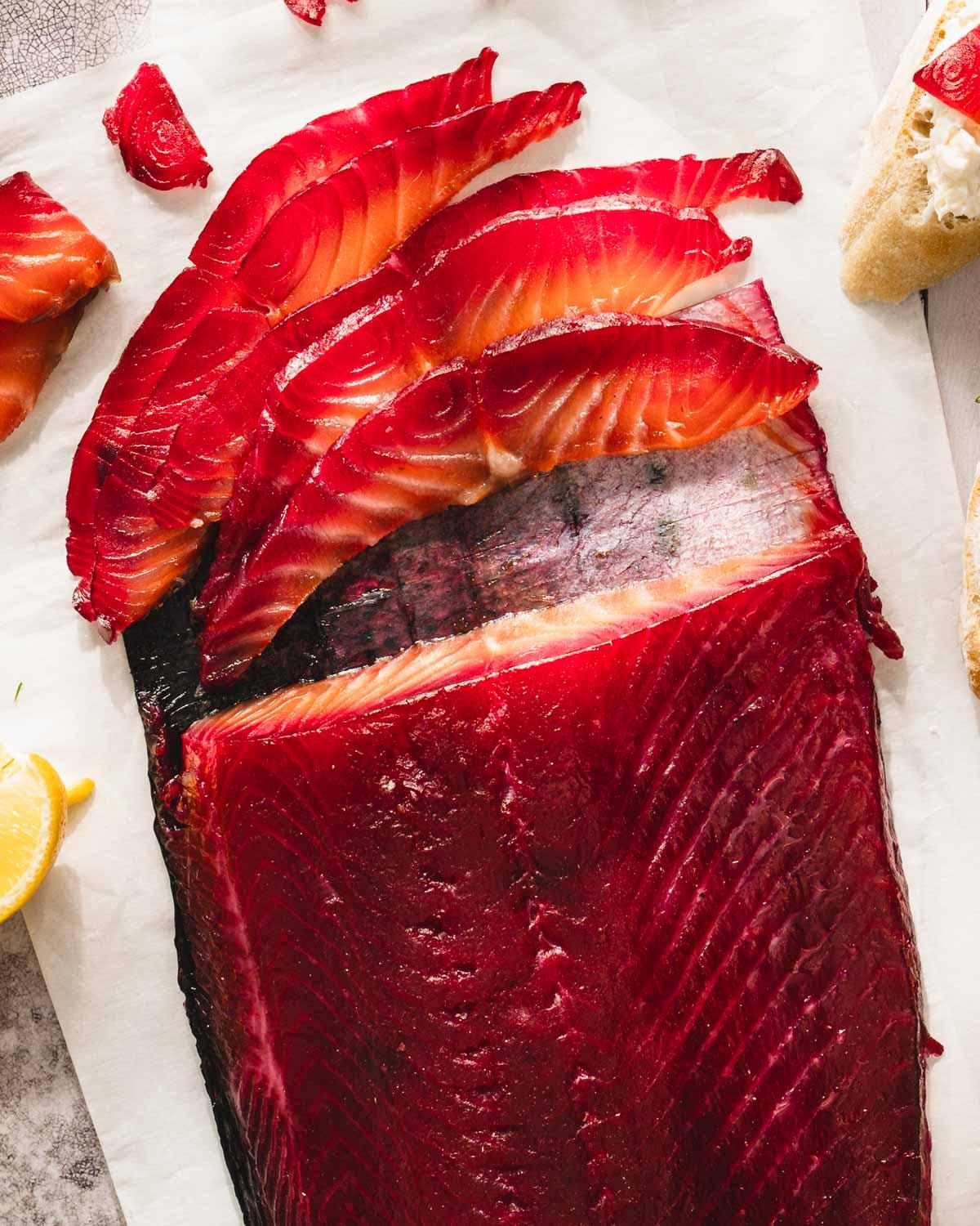Close-up of the salmon being layered with beetroot and horseradish mixture.