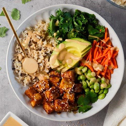 Close-up of a vibrant Asian Buddha bowl with crispy tofu