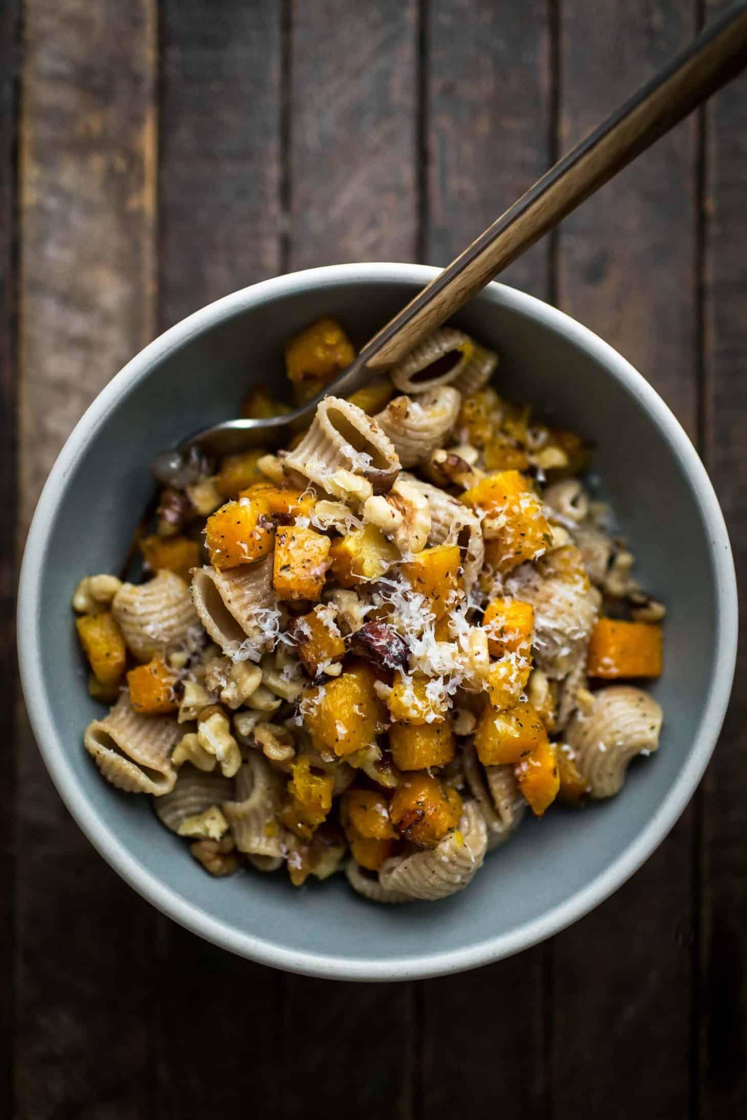 A person enjoying a large bowl of butternut squash pasta