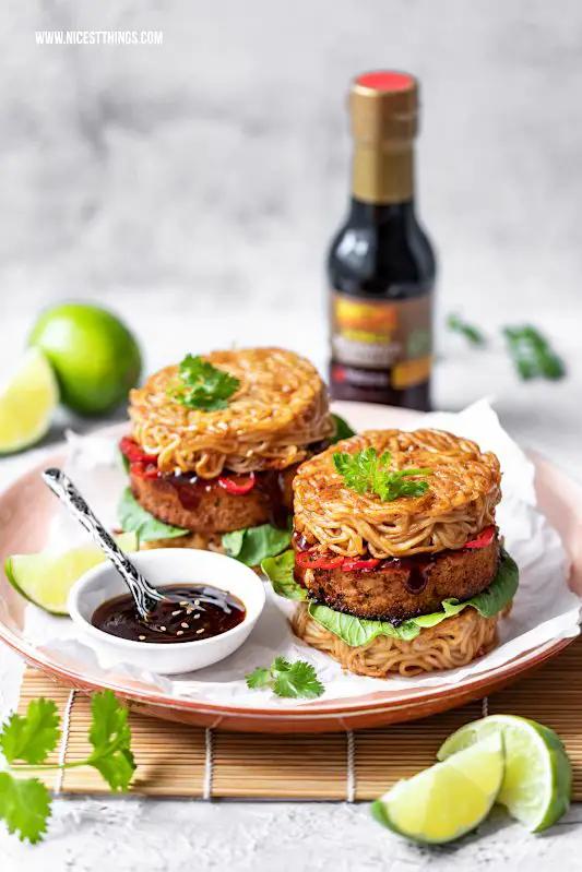 Close-up shot of a juicy ramen burger with perfectly seared bok choy, garnished with sesame seeds